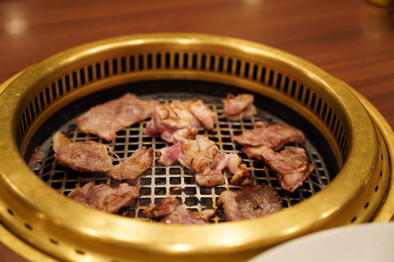 Example yakiniku grill with thin slices of meat cooking at the table